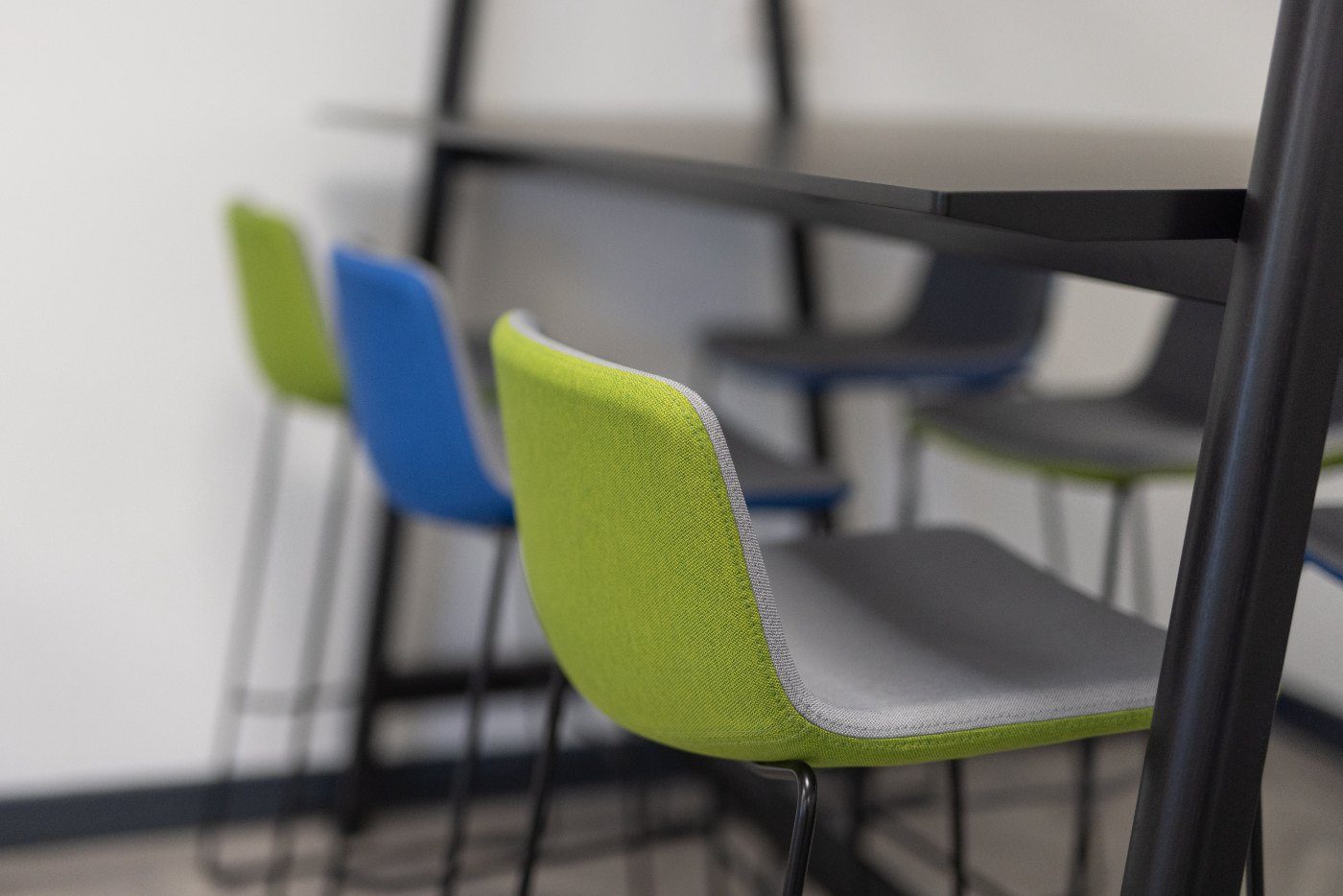 Green and blue upholstered chairs in a completed workspace