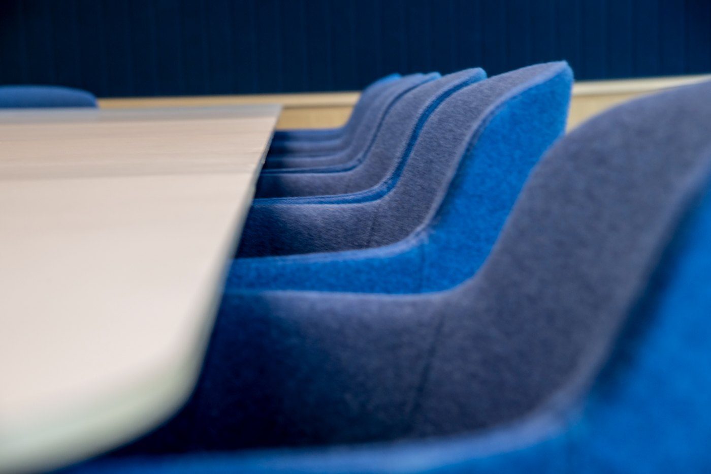 Blue upholstered meeting chairs at a boardroom table