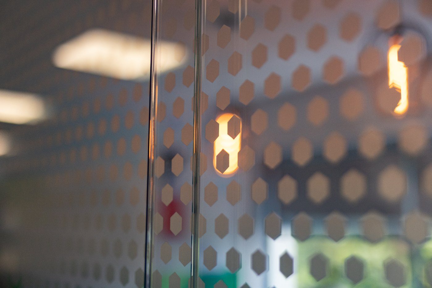 Perforated glazed screen detail with lighting behind